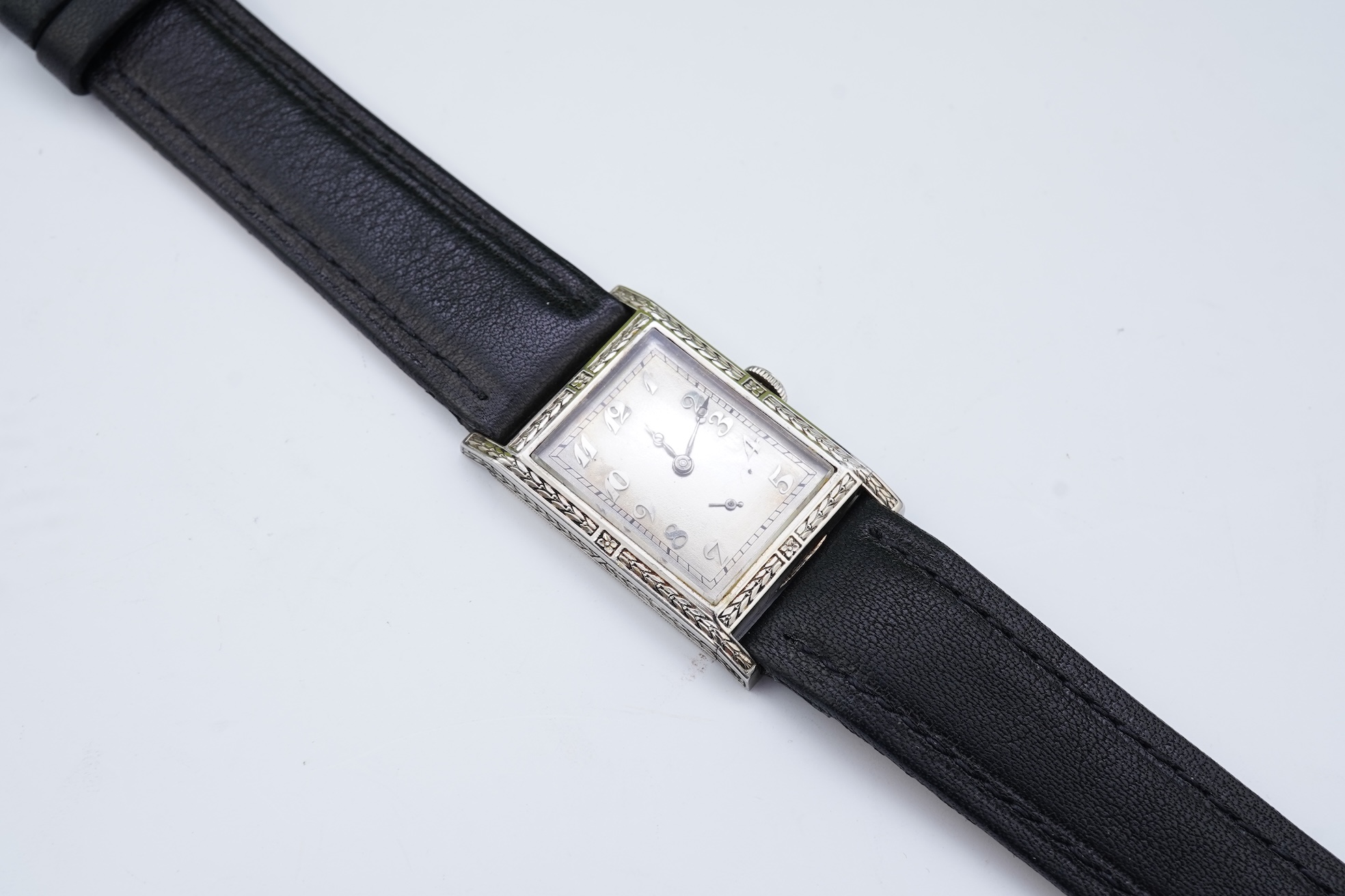 A lady's 18k white gold International Watch Company manual wind wrist watch, on a later associated leather strap